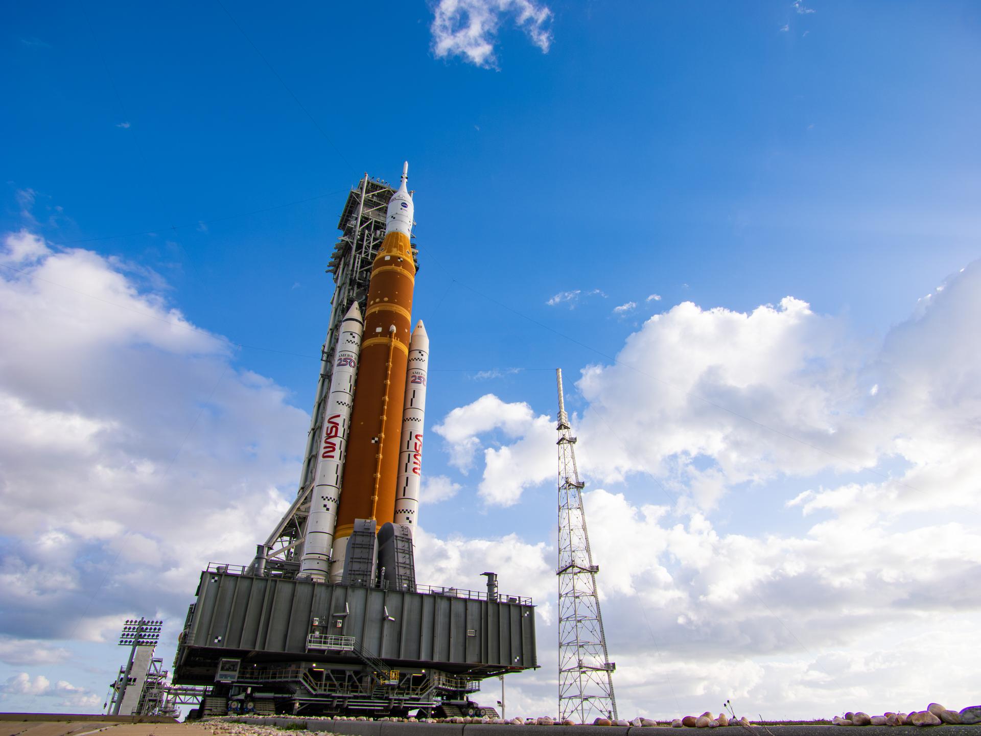 This image shows NASA’s SLS (Space Launch System) and Orion spacecraft rolling out of the Vehicle Assembly Building at NASA’s Kennedy Space Center. NASA's massive Crawler-Transporter, upgraded for the Artemis program, carries the powerful SLS rocket and Orion spacecraft on the Mobile Launcher from the Vehicle Assembly Building to Launch Pad 39B at Kennedy Space Center in preparation for the Artemis II mission.